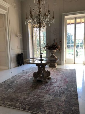 washed out persian rug with chandelier