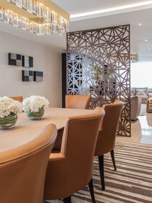 grey geometric rug in dinign room by katherine levitt design with tan leather chairs