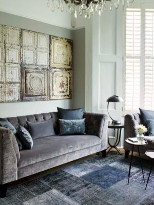 blue vintage patchwork rug in living room by Caz Myers