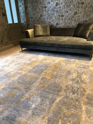 luxury wool and silk rug with velvet sofa